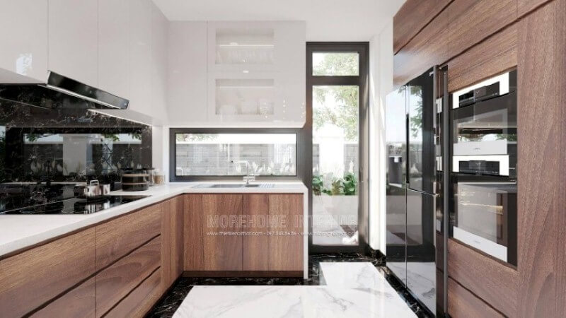 Với cách sắp xếp nội thất độc đáo, mẫu phòng bếp hiện đại trong đây sẽ là một mẫu thiết kế ấn tượng cho các không gian như nhà phố có sân vườn, biệt thự,.. Lối đi ra ngoài sân vườn, bạn có thể tận dụng trồng những cây rau thơm, gia vị; cánh cửa kính trắng giúp bạn có thể vừa nấu ăn vừa theo dõi hoạt động ngoài trời của con. Thiết kế phòng bếp, tủ bếp đẹp